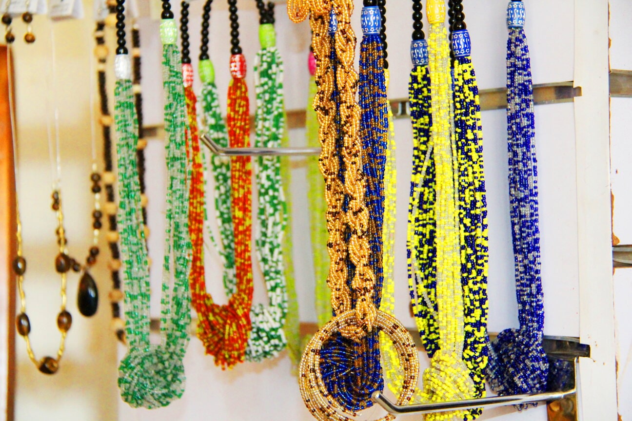 Long strands of colourful beads hanging on a display
