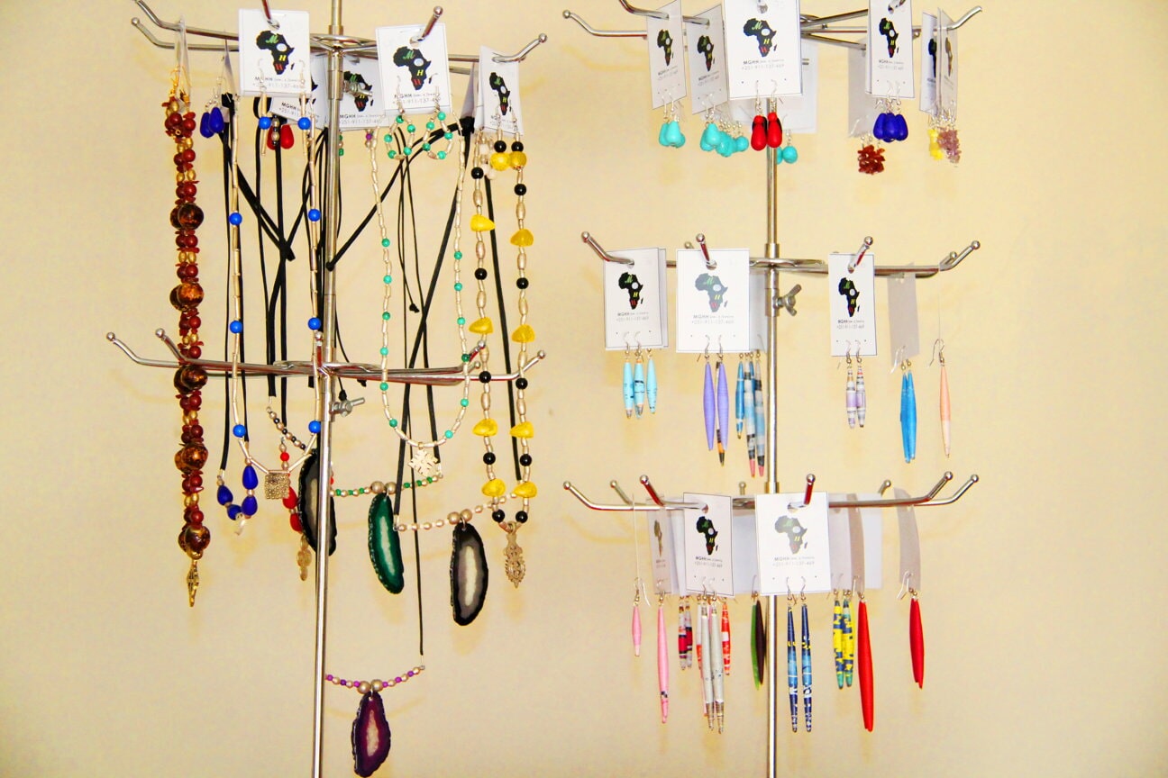 Earrings arranged on a white jewellery stand